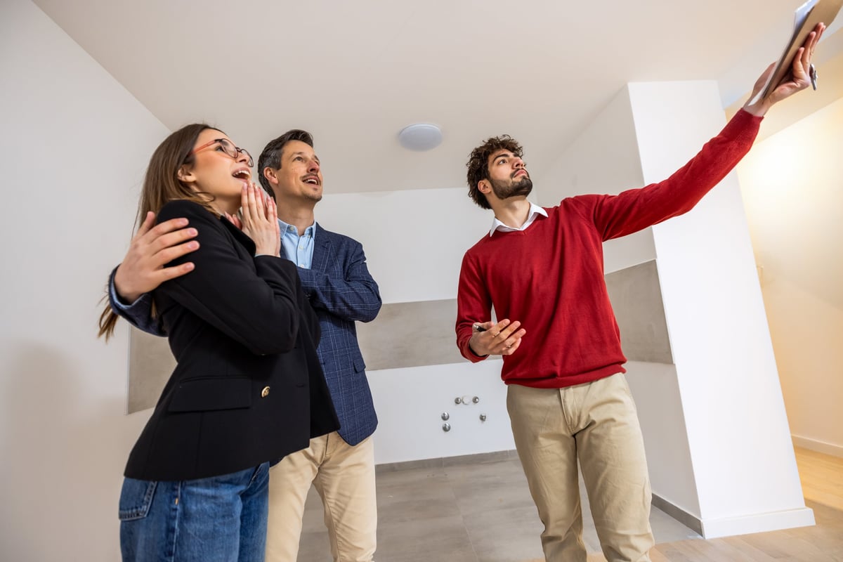 A couple delightedly viewing a bright, well-kept property